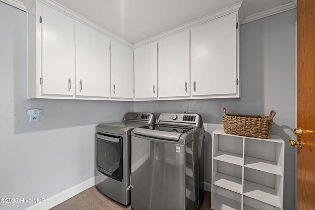 laundry area with baseboards, cabinet space, washer and clothes dryer, and carpet