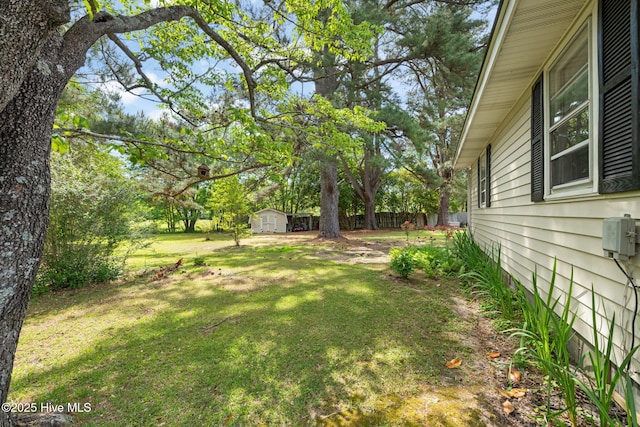view of yard featuring an outbuilding and a storage shed