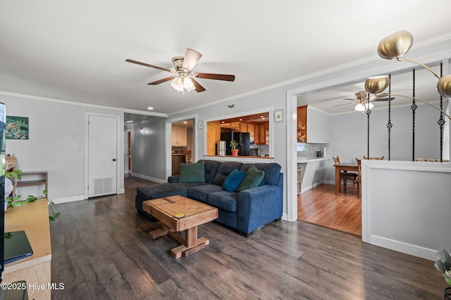 living room featuring crown molding, ceiling fan, wood finished floors, and visible vents