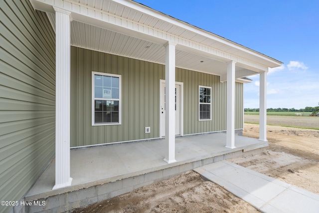 view of exterior entry featuring covered porch