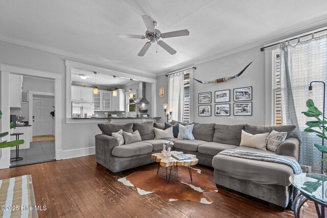 210 S 17th St, Wilmington, NC 28401 - living area featuring a ceiling fan, dark wood-style flooring, ornamental molding, healthy amount of natural light, and baseboards