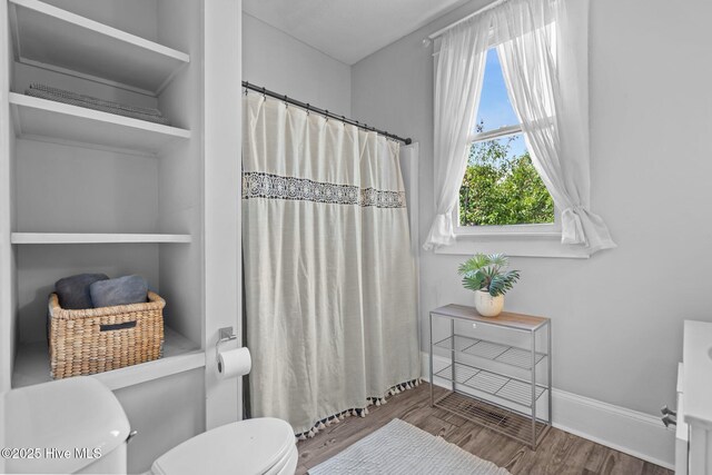 210 S 17th St, Wilmington, NC 28401 - full bathroom with toilet, wood finished floors, curtained shower, and baseboards