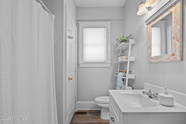 210 S 17th St, Wilmington, NC 28401 - full bath featuring toilet, wood finished floors, baseboards, and vanity