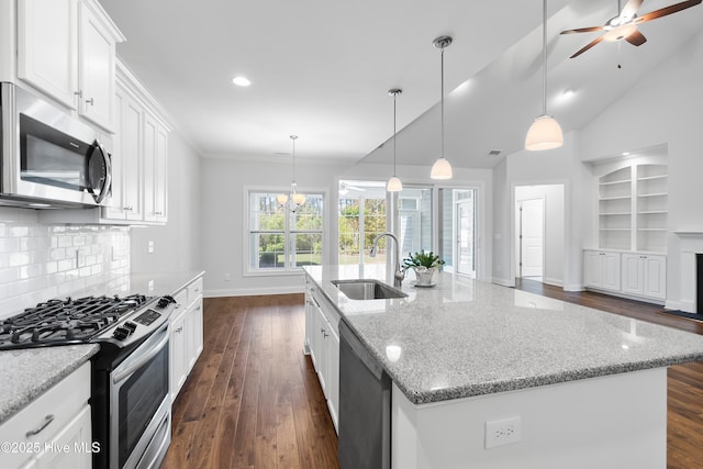 kitchen featuring dark wood-style flooring, stainless steel appliances, baseboards, and a sink
