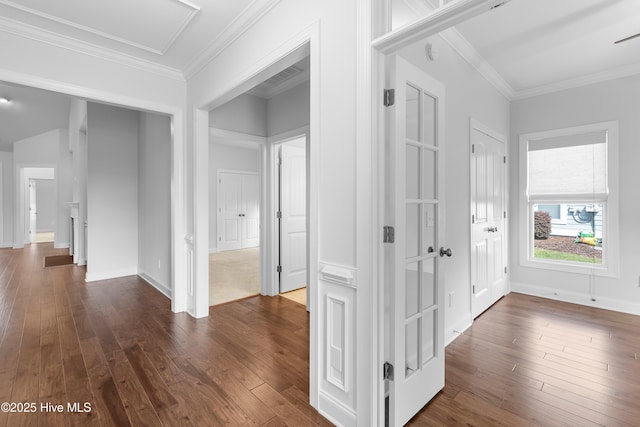 hall with crown molding, dark wood finished floors, and visible vents