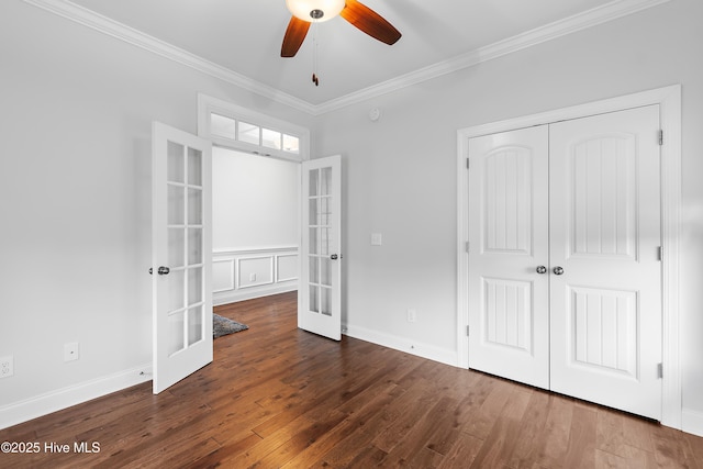 unfurnished bedroom featuring french doors, a ceiling fan, wood finished floors, ornamental molding, and a closet