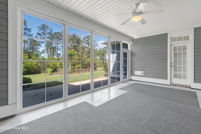 unfurnished sunroom with ceiling fan and a wealth of natural light
