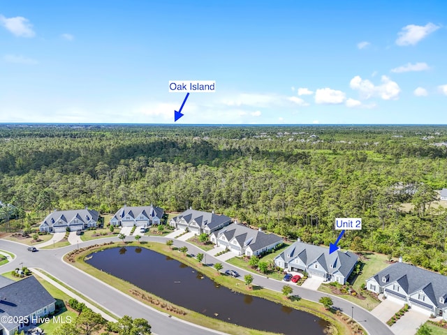 drone / aerial view with a water view, a residential view, and a wooded view