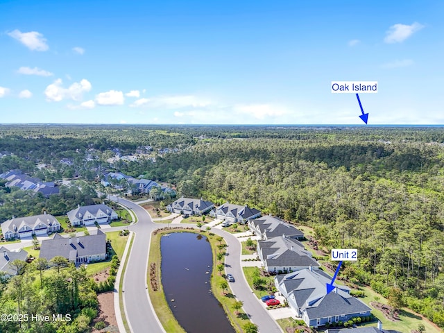 birds eye view of property with a water view, a view of trees, and a residential view