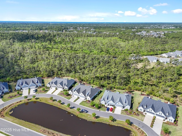 drone / aerial view with a water view, a residential view, and a forest view