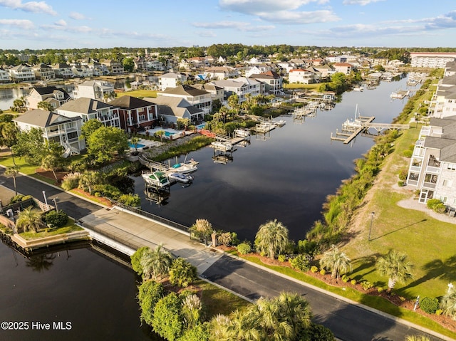 drone / aerial view with a water view and a residential view