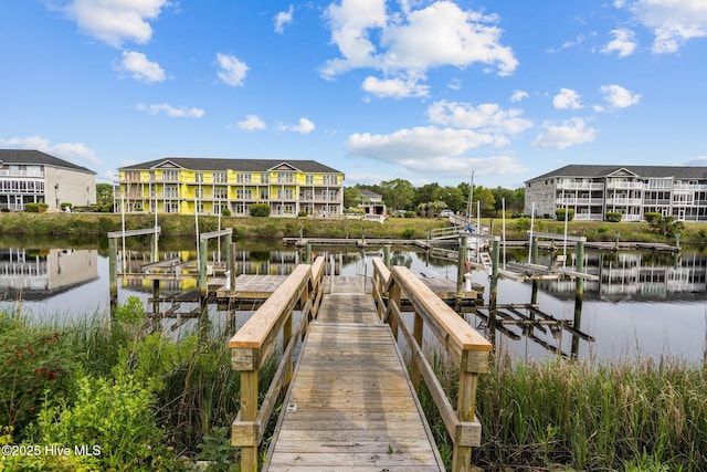 dock area featuring boat lift and a water view