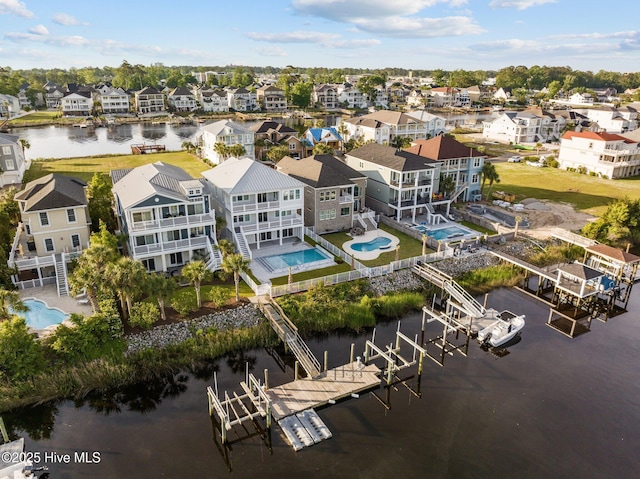 bird's eye view featuring a water view and a residential view