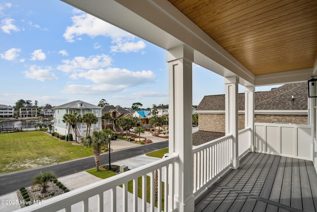 deck featuring a porch, a residential view, and a water view