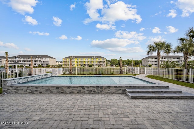 view of pool featuring fence, a residential view, and a fenced in pool
