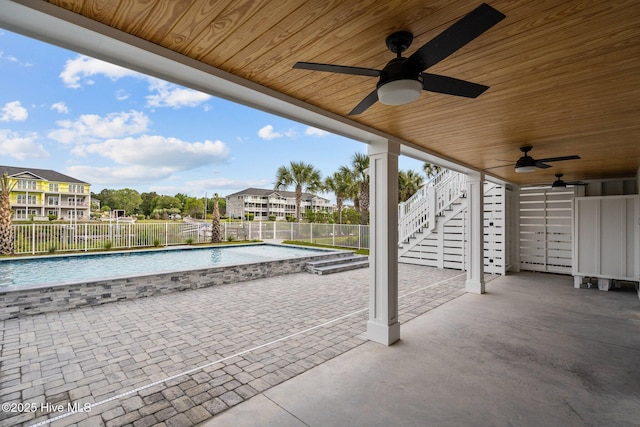 view of patio with a fenced in pool, a ceiling fan, stairs, and a fenced backyard