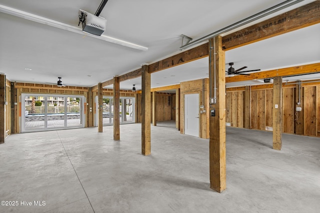 garage with a garage door opener and a ceiling fan