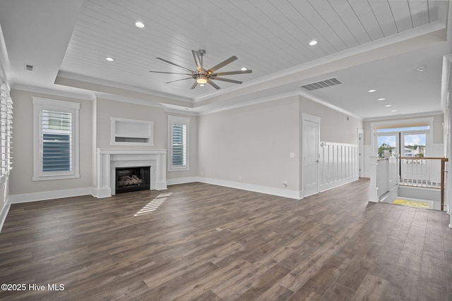 unfurnished living room with plenty of natural light, a raised ceiling, and wood ceiling