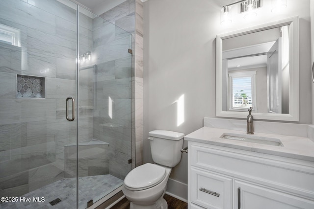 full bathroom featuring wood finished floors, toilet, vanity, visible vents, and a stall shower