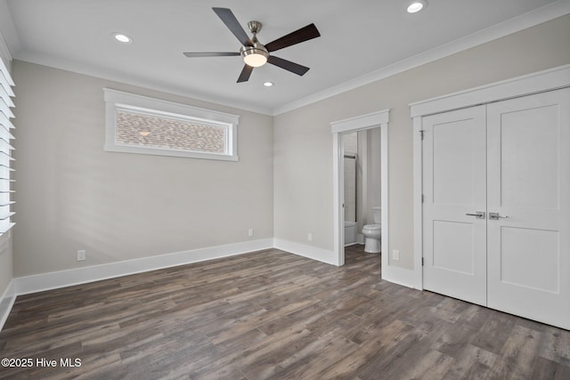 unfurnished bedroom with dark wood finished floors, recessed lighting, a closet, ornamental molding, and baseboards