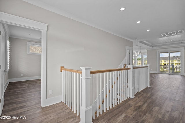hallway with recessed lighting, wood finished floors, an inviting chandelier, an upstairs landing, and visible vents