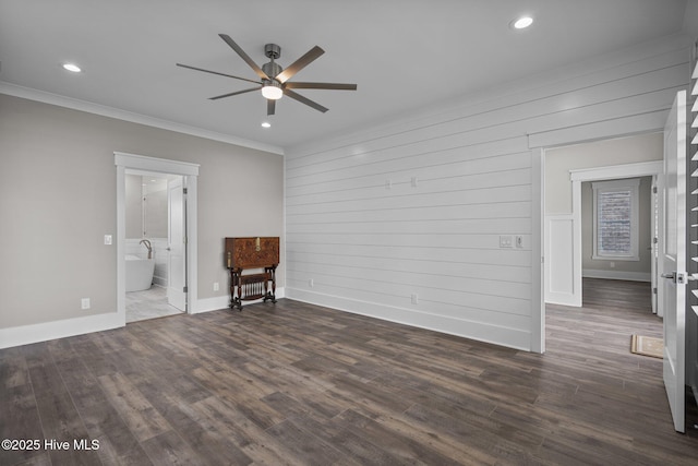 interior space with dark wood-style flooring, a ceiling fan, ornamental molding, and baseboards