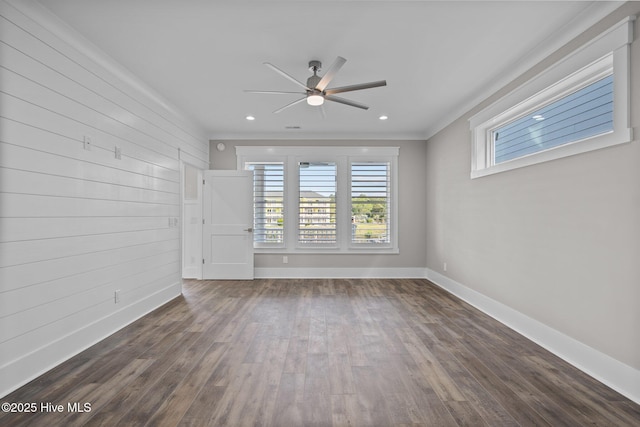 empty room with recessed lighting, wood finished floors, ornamental molding, baseboards, and a ceiling fan