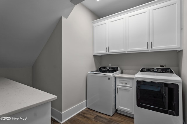 washroom with baseboards, cabinet space, dark wood-type flooring, and independent washer and dryer