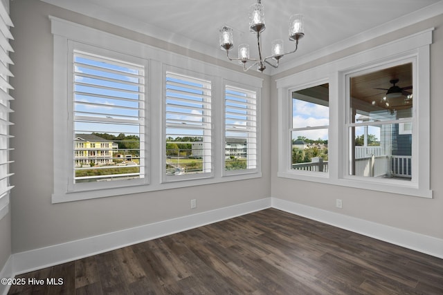 unfurnished dining area with baseboards, an inviting chandelier, and dark wood-type flooring