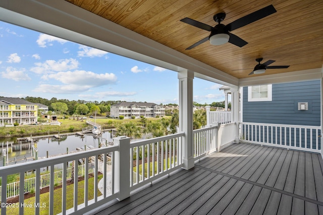 wooden deck featuring a water view and ceiling fan