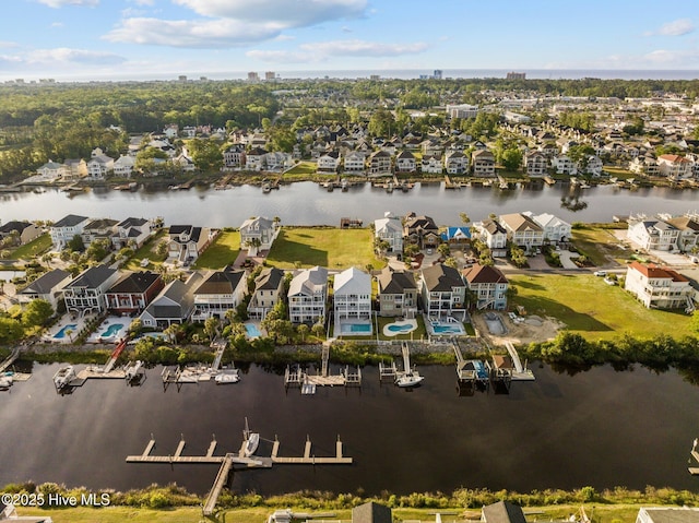 drone / aerial view with a residential view and a water view