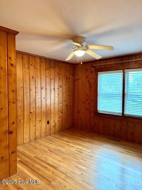 407 Main St, Bayboro, NC 28515 - unfurnished room featuring visible vents, a ceiling fan, wood finished floors, and wood walls
