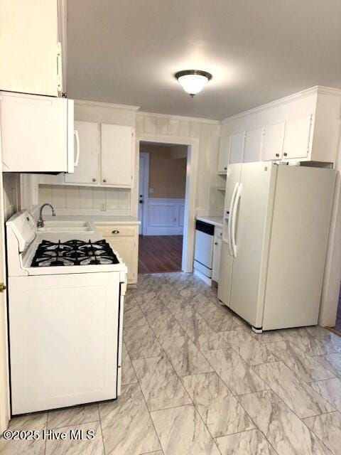 407 Main St, Bayboro, NC 28515 - kitchen with white cabinets, a sink, white appliances, light countertops, and marble finish floor