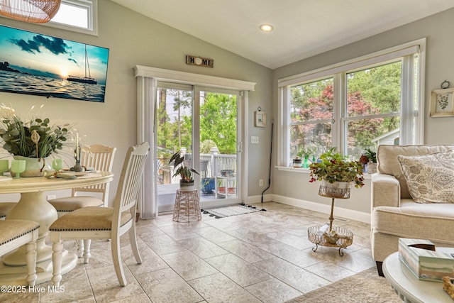 interior space with baseboards, recessed lighting, stone tile flooring, and vaulted ceiling