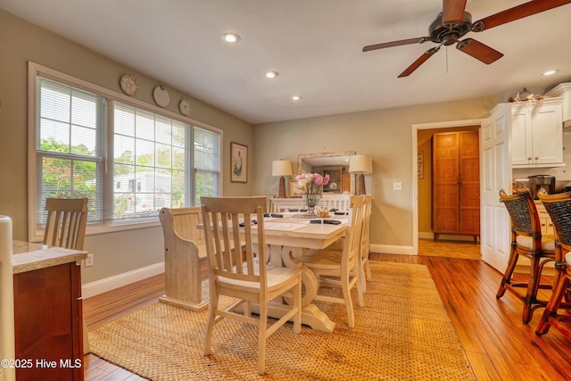 dining area with baseboards, recessed lighting, a ceiling fan, and light wood-style floors