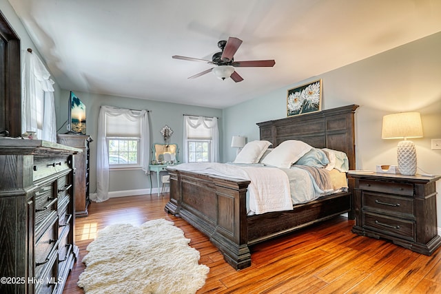 bedroom with baseboards, wood finished floors, and ceiling fan