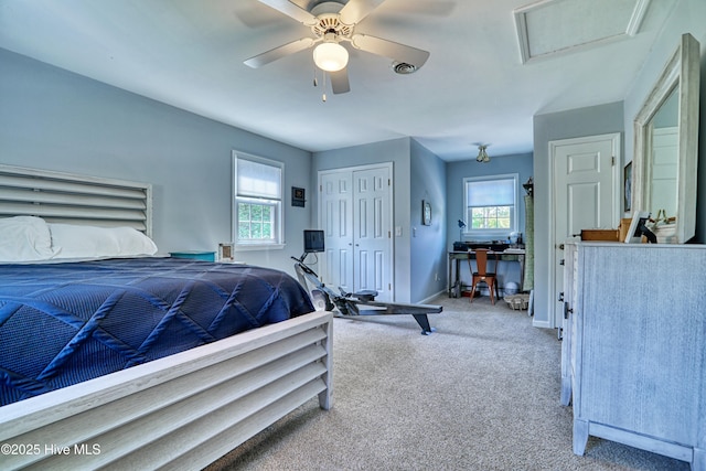 bedroom with carpet flooring, a closet, baseboards, attic access, and a ceiling fan
