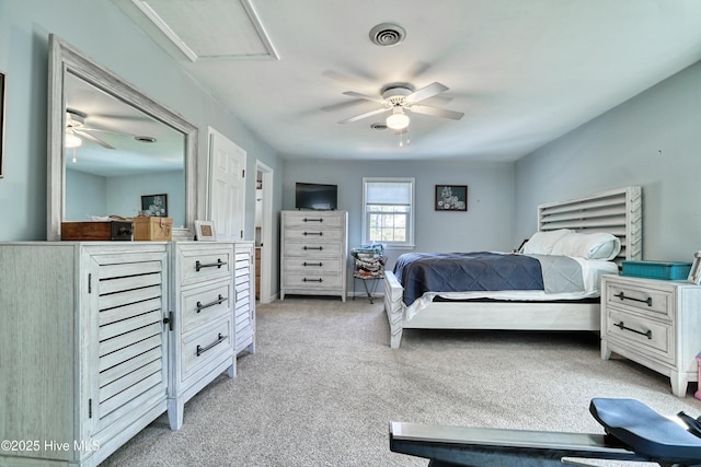 bedroom featuring visible vents, a ceiling fan, and light carpet