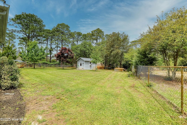 view of yard featuring a fenced backyard, a shed, and an outdoor structure