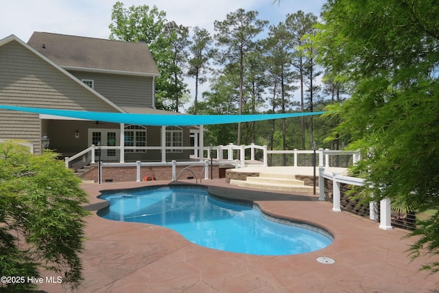 pool with a patio area and french doors