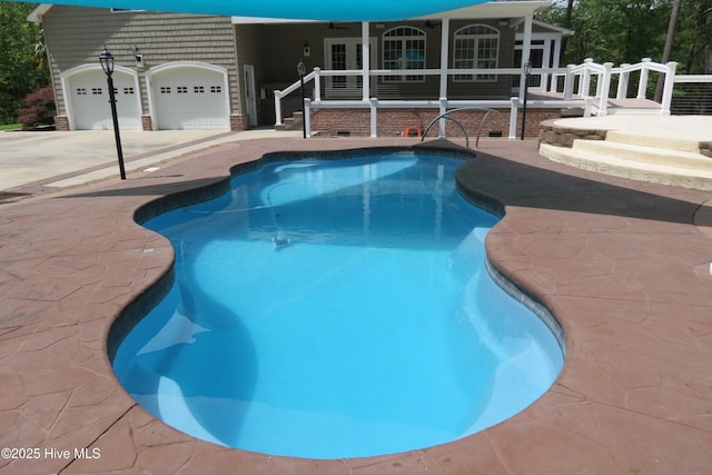 pool featuring a ceiling fan and a patio area
