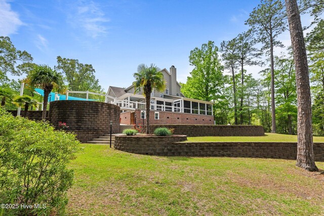 view of yard featuring a sunroom