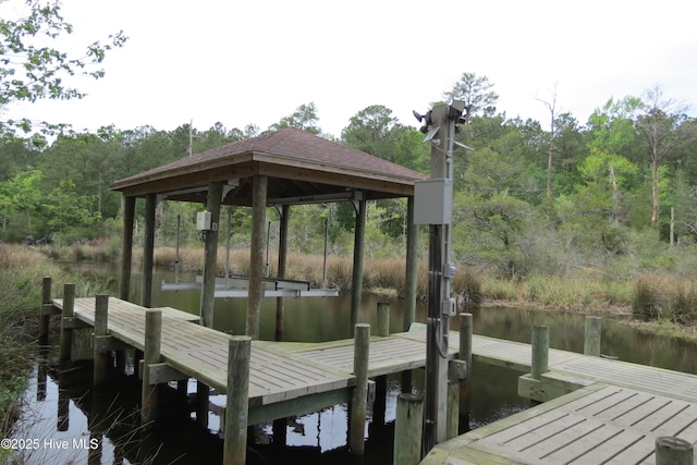 view of dock featuring a water view and a view of trees