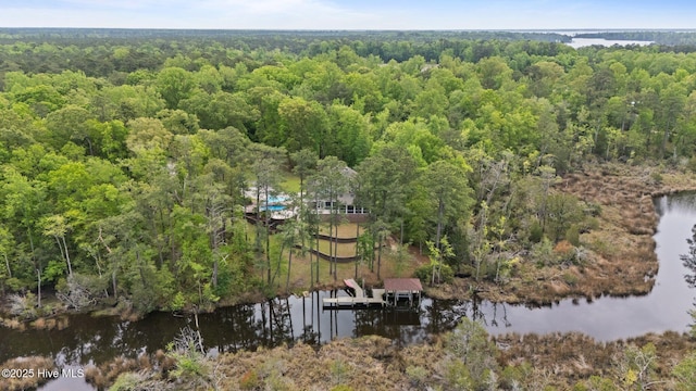 aerial view featuring a wooded view and a water view