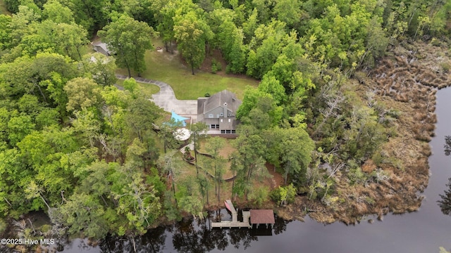 drone / aerial view featuring a forest view and a water view