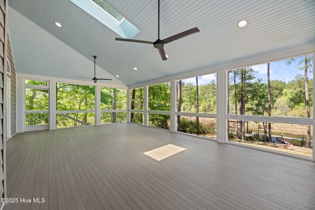 unfurnished sunroom featuring a skylight and a ceiling fan