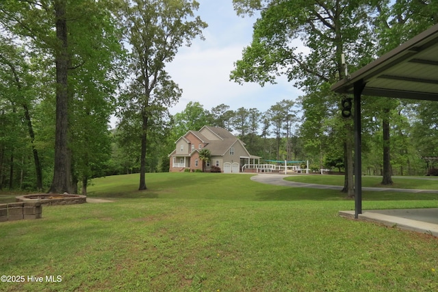 view of yard with an attached garage and volleyball court
