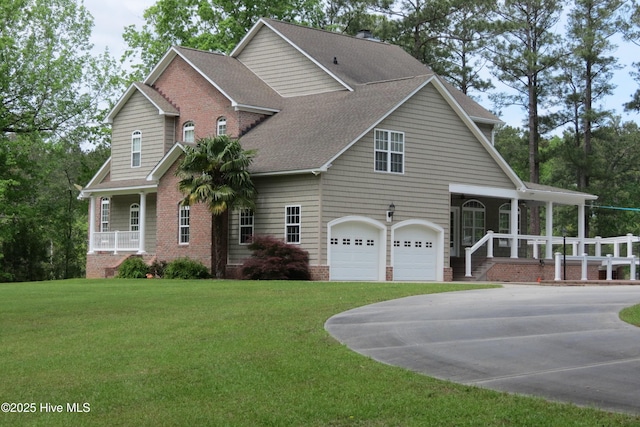 view of front facade with a shingled roof, a porch, and a front yard