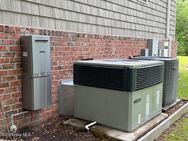 exterior details with cooling unit and brick siding