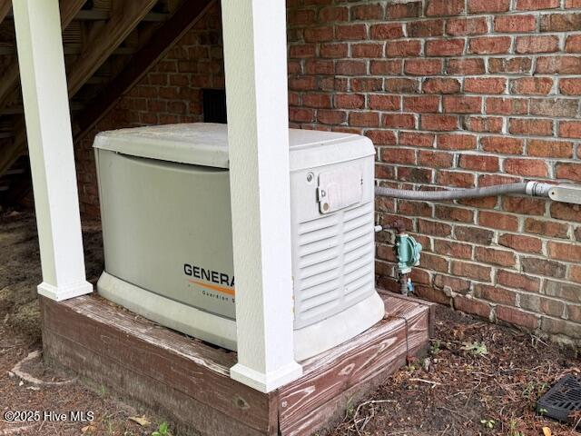 exterior details featuring brick siding and a power unit